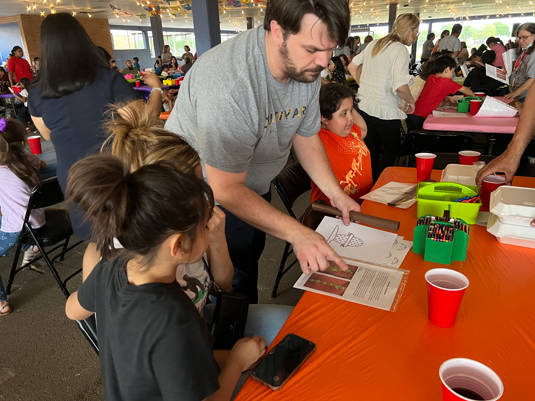 person helping kids with activity